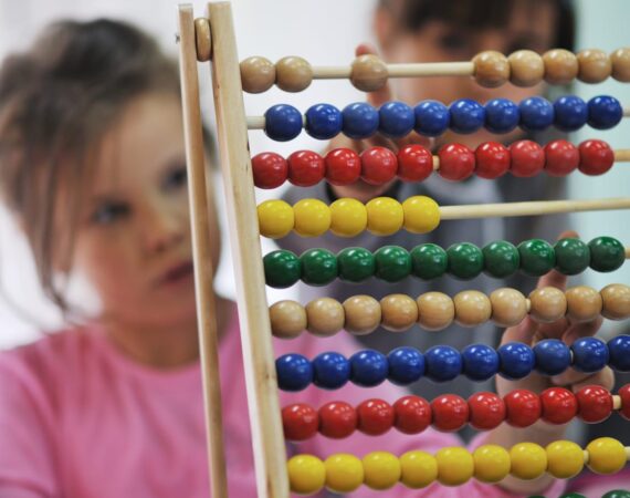 Pre-school children learning about an abacus