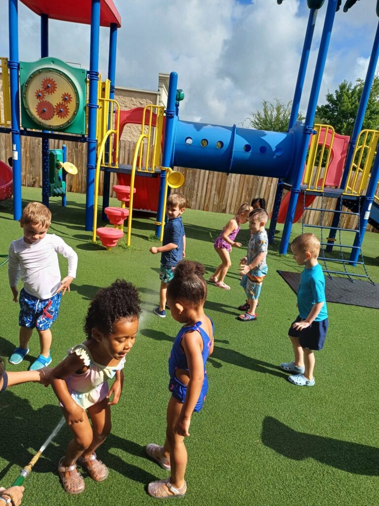 Kids on the playground at Creative Childcare Academy and Camp
